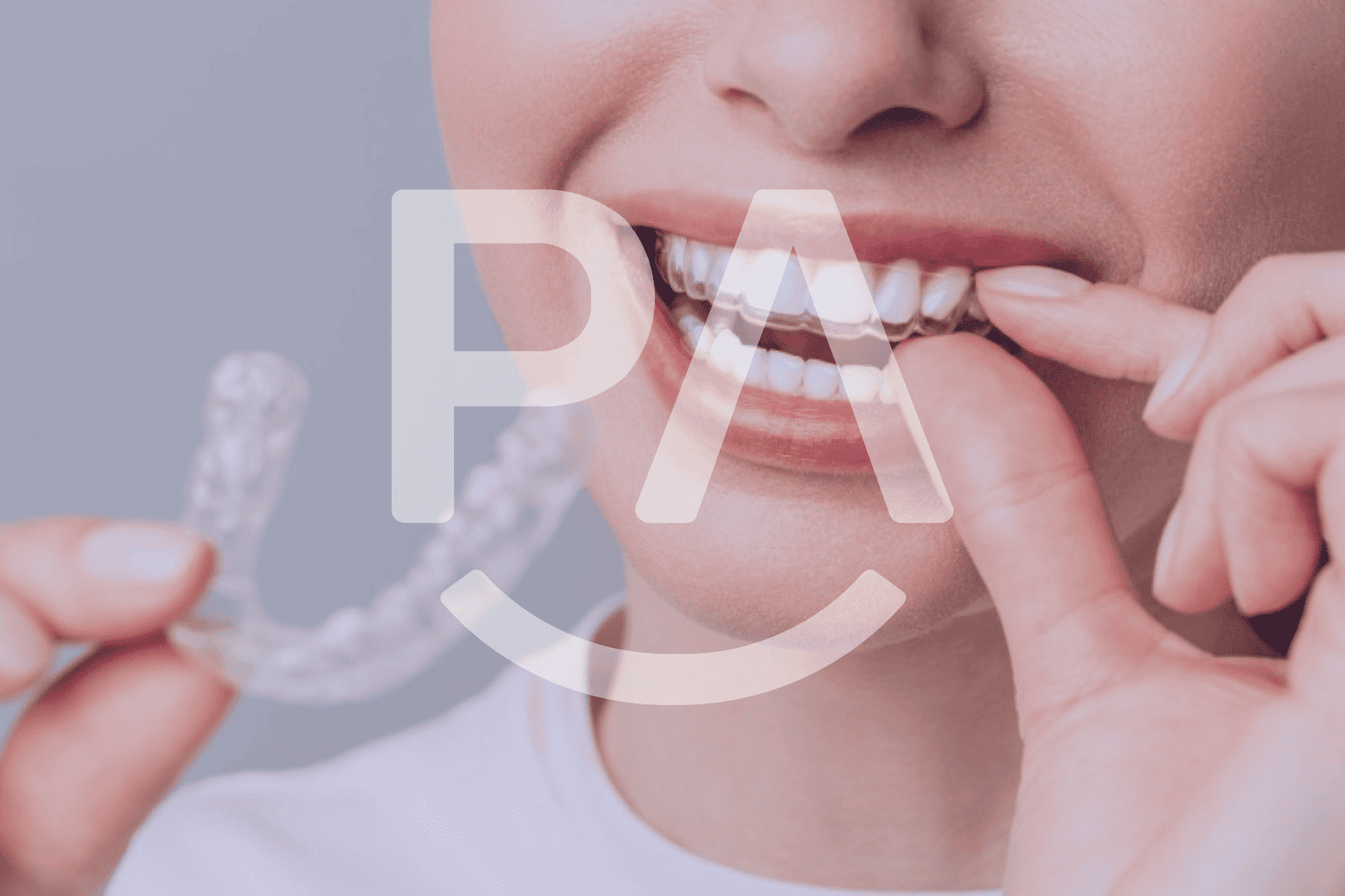 Person wearing clear aligners and smiling