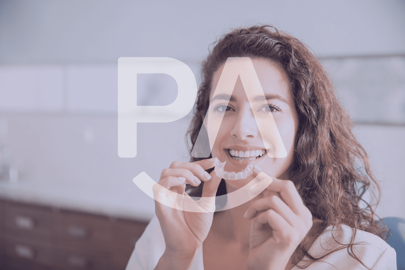 A woman smiling and holding a ParisAline aligner case, ready to switch to the next tray.